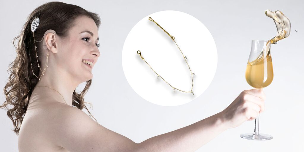 Woman wears silver foil cochlear hearing aid cover and chain in gold over her hair
